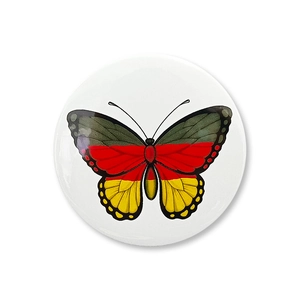 Detailed view of a German flag themed butterfly badge with a glossy round finish