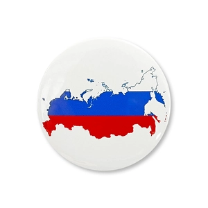 Macro shot of circular tinplate badge featuring Russia map outline and flag colors