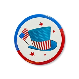 Close-up of Independence Day tinplate badge with USA flag and patriotic top hat design