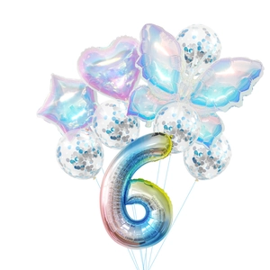 Close-up of number 6 gradient balloon with butterfly and sequins for birthday decor