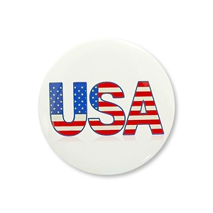 Detailed macro view of a round USA tinplate badge featuring patriotic American flag patterns