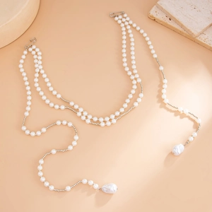 Multilayer faux pearl waist chain with star tassels and baroque pendants on a beige base