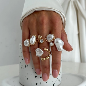 Minimalist liquid metal gold ring set with baroque pearls and rhinestones on model