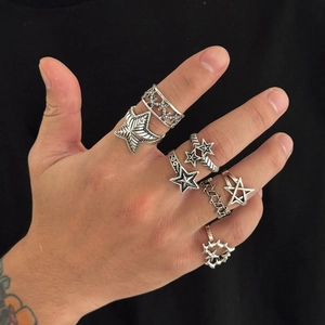 Close-up of vintage silver star rings set for men with gothic chain patterns on hand