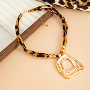 Detailed shot of leopard print necklace strap with gold beads and a hollow alloy pendant