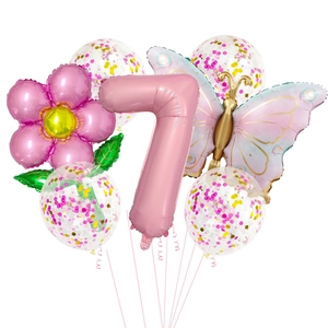 Detail of flower and butterfly foil balloons with pink number seven for party decor
