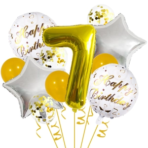 Macro detail of golden number 7 balloon set with star shapes for birthday party decoration