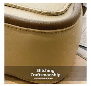 Detailed close-up of double-stitched seams on the beige PU leather saddle bag texture