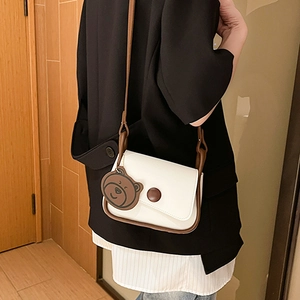 Minimalist square crossbody bag with cream and brown contrast trim and bear charm