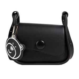 Minimalist black saddle shoulder bag with round buckle and cartoon bear charm accessory