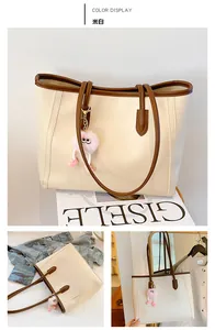Detailed views of a cream faux leather tote bag with brown straps and a pink charm