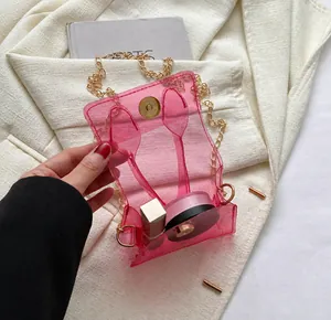 Détail de capacité du mini sac en PVC rose transparent avec chaîne et maquillage