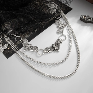 Detail of gothic multi-layer moth pants chain with skull pendants on black lace
