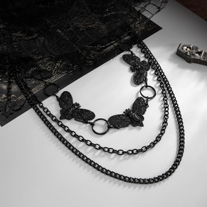Detailed view of dark gothic multi-layered waist chain with black moth pendants and accents