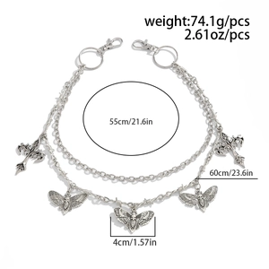 Detail of double-layer silver chain with butterfly and gothic cross charms for jeans