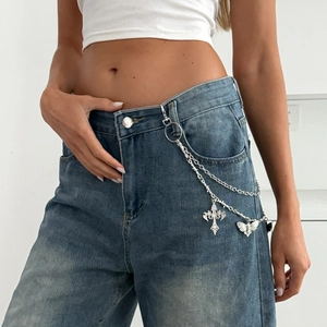 Detail of silver layered waist chain with vintage cross and hollow butterfly pendants