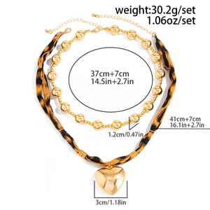 Detail of leopard print necklace and golden heart pendant with size measurements
