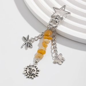 Detailed view of vintage star clasp keychain with sun, butterfly charms and citrine stones