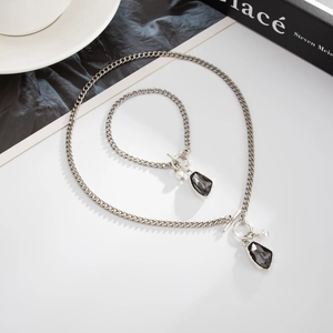 Vintage silver necklace and bracelet set with irregular dark crystals and pearl details