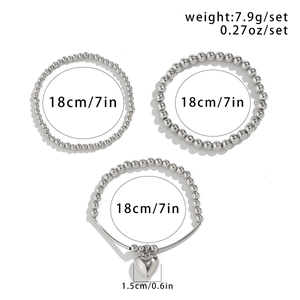 Detailed view of silver beaded bracelet set with heart charm and size specifications