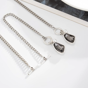 Detail of silver link chain with toggle clasp and irregular grey crystal pendant