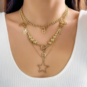Close-up of golden multi-layer star pendant necklace with OT buckle on a model