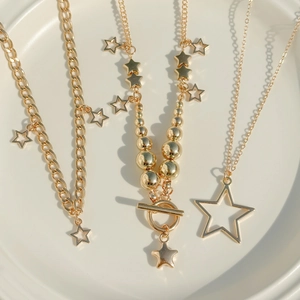 Close-up of gold baroque star necklace set with toggle clasps and textured metal chains