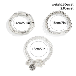 Detailed set of silver-toned metal bracelets featuring bamboo texture and embossed pendants