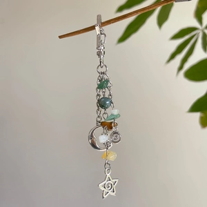 Star moon sun pendant keychain with natural stone crystals on green branch