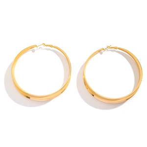 Minimalist wide flat golden metal hoop earrings featuring a polished bold circular design