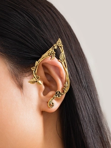 Detailed close-up of a vintage gold vine ear cuff with delicate leaves and roses