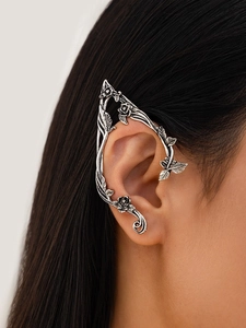 Detail of vintage silver elf ear cuff with rose flower and leaf texture on model