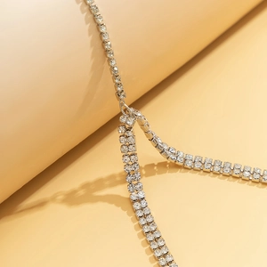 Detailed view of silver-toned multi-strand rhinestone thigh chain with sparkling crystals