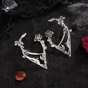 Detail of gothic silver elf ear cuffs featuring vintage rose and vine relief textures