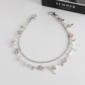 Close-up of double-layered silver waist chain with pink beads and heart bow pendants