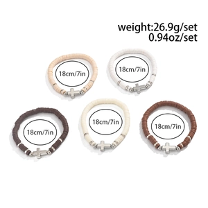 Detail of 5-piece bohemian beaded bracelet set with silver crosses and clay beads