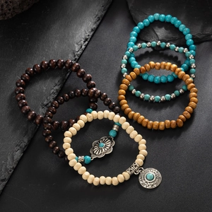 Detail view of bohemian wood bead bracelet set with turquoise and silver pendants