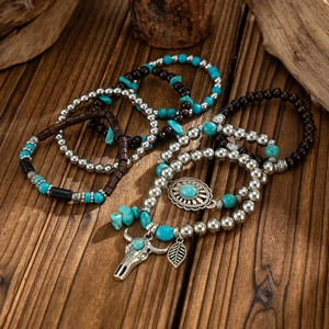 Detail of bohemian multilayer bracelet set with turquoise beads and silver metal charms