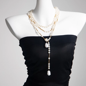 Détail du collier de perles multicouche avec chaîne en étoile et pendentif baroque