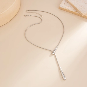 Detailed view of silver long tassel Y-necklace with polished water-drop pendants on snake chain