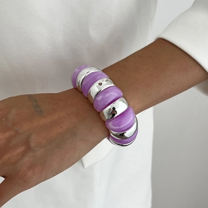 Detail of chunky purple marble resin and silver metal chain bracelet on a model