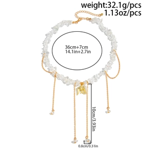 Macro detail of gravel stone necklace with bird pendant and tassel fringe dimensions