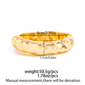 Detailed measurements of a wide irregular gold textured cuff bracelet with 6cm diameter