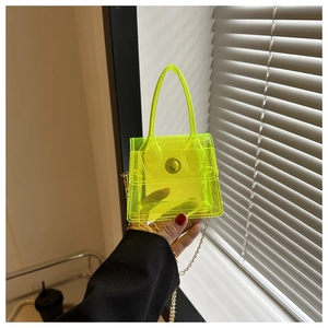 Détail du mini sac transparent en PVC vert néon avec chaîne dorée et boucle en métal