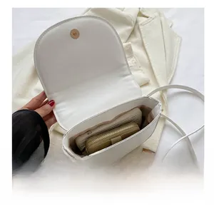 Interior view of white saddle bag showing capacity for phone and long wallet