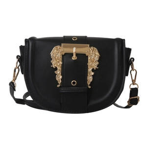 Chic black saddle crossbody bag featuring ornate gold baroque buckle and adjustable strap