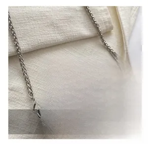 Macro detail of heart-shaped crossbody bag with silver rhinestones and metal chain