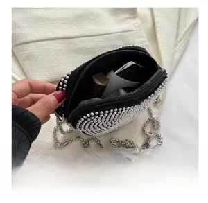 Capacity detail of mini black crossbody bag with silver rhinestones and chain strap