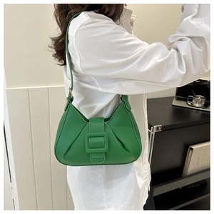 Detailed close-up of green pleated shoulder bag with square buckle and pu leather texture
