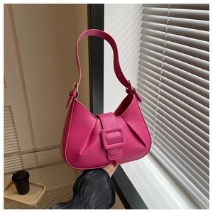 Detail of rose red pleated PU leather shoulder bag with large square buckle decoration